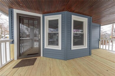 The full-length front porch with new decking and new front door