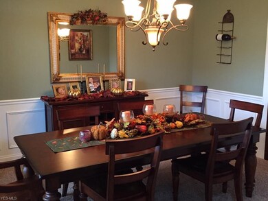 Dining room with recessed lighting and wainscoting