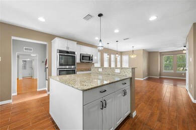 Kitchen with stainless steel appliances, baseboar