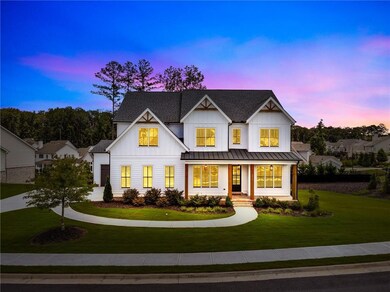 Modern farmhouse style home with board and batten siding, a front yard, a standing seam roof, a porch, and a metal roof