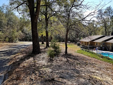 Driveway view of house pool