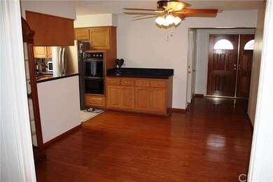Dining area under ceiling fan with view of front d