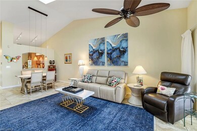 Living room featuring a ceiling fan, vaulted ceili