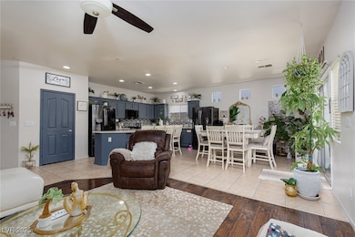 Living area with a ceiling fan, recessed lighting,