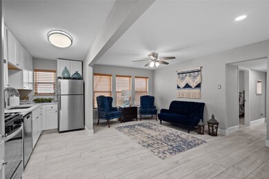 The living/kitchen/dining area has grey/white faux