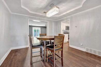 Dining space featuring ornamental molding, a tray 