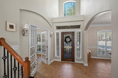 Open the door to architectural details from the sidelight windows, a transom window, arched walkways and pretty windows with Plantation shutters! Tile flooring flows from the entry, into the formal dining, study, down the hall and into the kitchen!