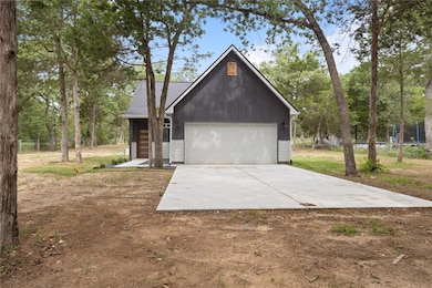 View of front of home with concrete driveway, a g