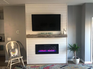 Living room featuring baseboards, a fireplace, and