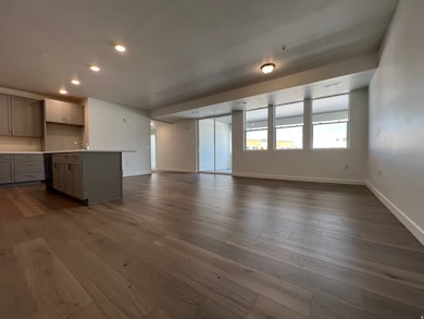 Unfurnished living room with dark wood finished floors and recessed lighting