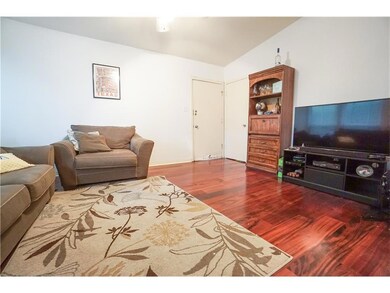 Living area with wood finished floors and lofted 