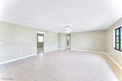 Tiled empty room with ceiling fan