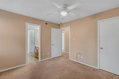Unfurnished bedroom with ceiling fan, connected ba