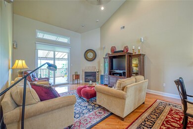 Living room area with gas fireplace and vaulted ce