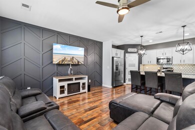 Living room with dark wood-type flooring and ceili
