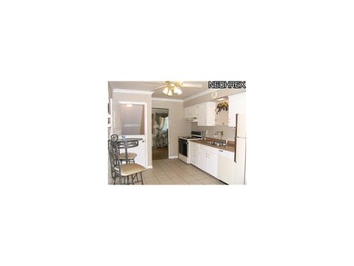 Bright white cabinetry with new counter tops and c