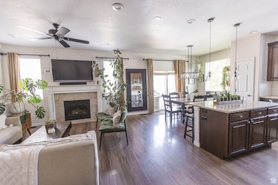 Open concept living room and kitchen with fireplace