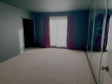 This room features a spacious bedroom with carpete