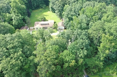 Aerial view of property's location with a forest