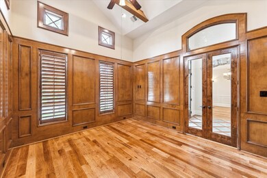 Stunning home office adorned with rich wood paneli