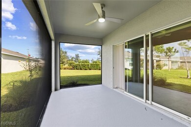 Unfurnished sunroom featuring a ceiling fan and a patio