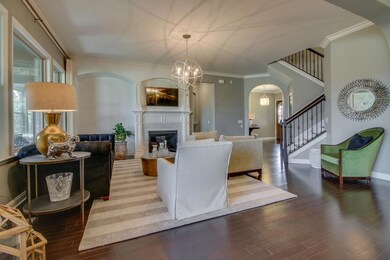 The Great Room includes Surround Sound, a chandelier, and an architectural nook framing the fireplace. 
