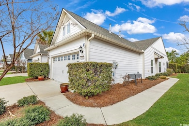 View of property exterior featuring a garage, roof with shingles, and driveway