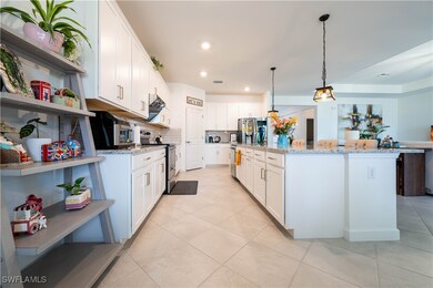 Kitchen featuring white cabinetry, open shelves, l