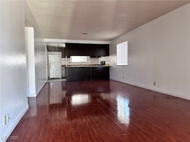 Unfurnished living room with dark wood-style floor