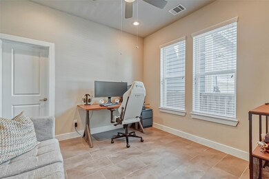 The first floor bedroom/office features high ceili