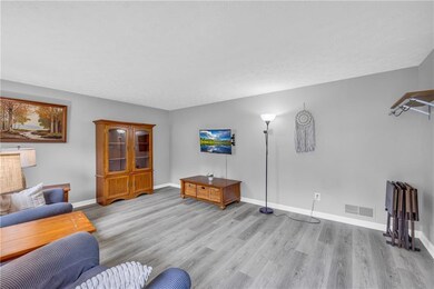 Living area with light wood-style floors and baseboards