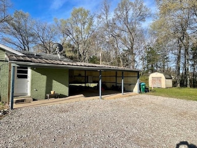 View of shed with an attached carport