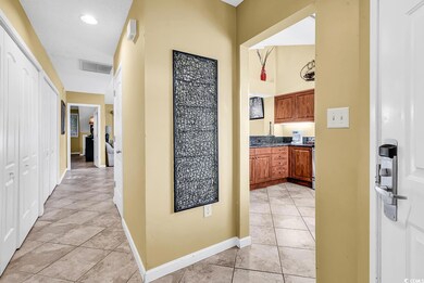 Hallway with baseboards, light tile patterned flooring, and recessed lighting
