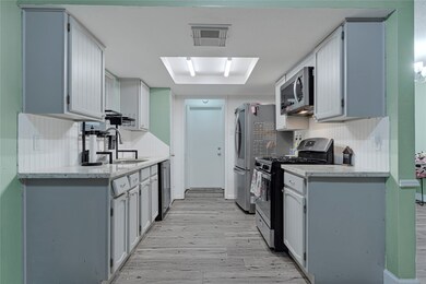Kitchen offers stainless steel microwave, stove an