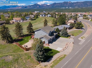 Aerial view of property and surrounding area featuring nearby suburban area and mountains