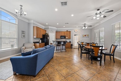 Tiled living area with baseboards, recessed light