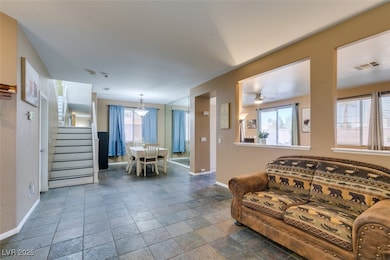 Living area featuring stairway, stone tile floorin