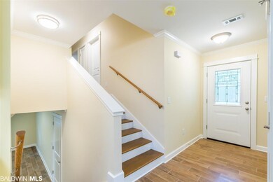 FOYER AND STAIRS LEADING TO 3 BEDROOMS