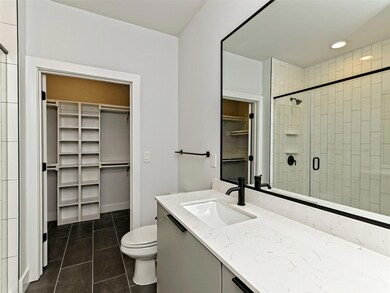 Bathroom with tile patterned flooring, toilet, a 