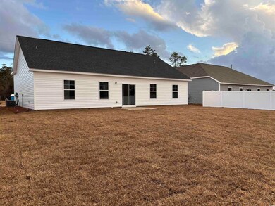 Back of house with a yard and central AC unit