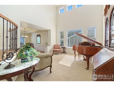 Living room is open and bright with cathedral ceilings a large windows