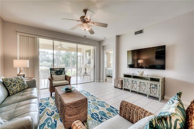 Tiled living area featuring a ceiling fan, visible