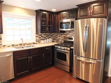 Kitchen has beautiful quartz countertops and tile 