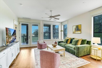 Living area with ceiling fan and light wood-style