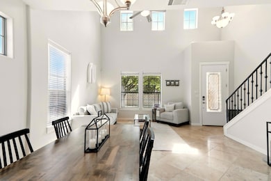 Dining space with a chandelier, a high ceiling, s