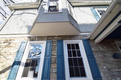 Beautiful shutters, stonework and decorative cedar