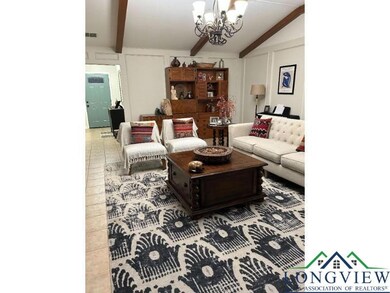 Living area with a chandelier and a decorative wall