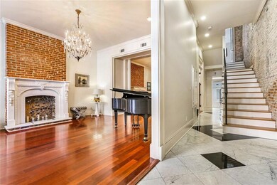 A highly polished marble foyer and gleaming hardwo