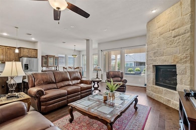 Living room with a textured ceiling, a fireplace, 