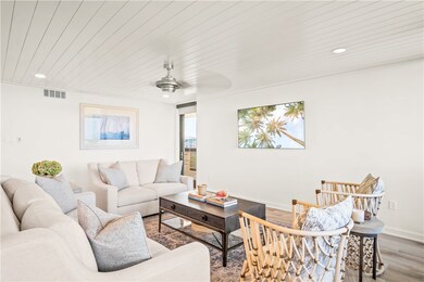 The living room has access to a balcony overlookin